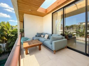 a living room with a couch and a table at Village Berawa in Badung