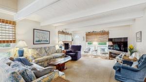 a large living room with couches and a fireplace at Bethany West - 702 Radial Dr in Bethany Beach
