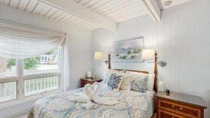 a bedroom with a bed with two swans on it at Bethany West - 702 Radial Dr in Bethany Beach