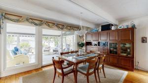 a kitchen with a table and chairs and a large window at Bethany West - 702 Radial Dr in Bethany Beach +24 photos