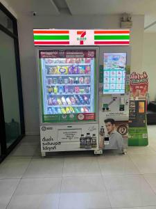 a soda machine in a store with a picture of a man at Living avenue condominuim in Ban Rong Khoei