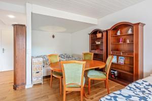 a bedroom with a dining room table and chairs at Beautiful Apartment in Häusern