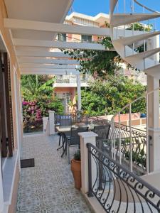 a patio with tables and chairs on a building at Villa Chrisanthi in Parga