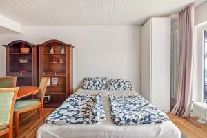 a bedroom with a bed and a desk and a table at Beautiful Apartment in Häusern +14 photos