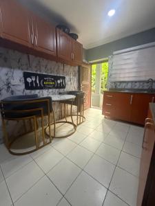 a kitchen with a table and chairs in it at Max Heron in Ikeja