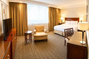 a hotel room with a bed and a television at Regal Pacific Puerto Madero in Buenos Aires