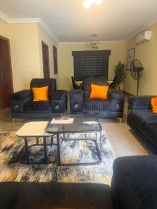 a living room with couches and a coffee table at Max Heron in Ikeja