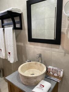 a bathroom with a sink and a mirror at Ntaba Villas in Port St. Johns