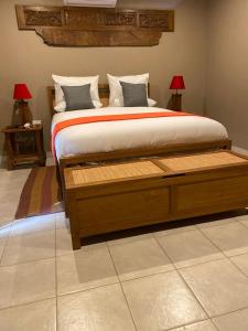 a bedroom with a large bed with two lamps at Ntaba Villas in Port St. Johns +9 photos