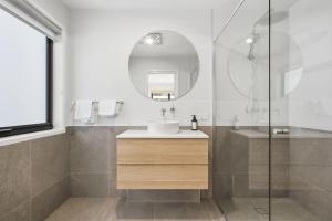 a bathroom with a sink and a mirror at Modern Lindisfarne Escape in Lindisfarne +59 photos