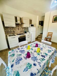 a kitchen with a table with three rubber ducks on it at Appartamenti Abbaidda in Valledoria