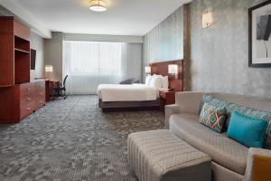 a hotel room with a bed and a couch at Courtyard by Marriott Ottawa East in Ottawa +52 photos