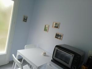 a room with a table and a tv and a table and a table at le studio de la salamandre in Cadillac