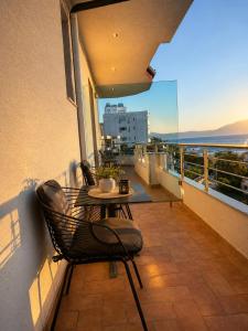 a patio with a table and chairs on a balcony at Hotel Albsin in Vlorë