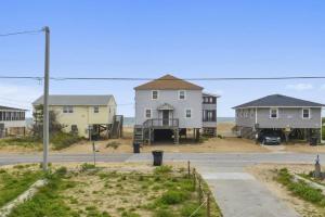 a group of houses on a street next to a road at 4073 - Downtime in Kitty Hawk