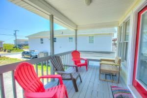 a porch with three chairs and a table and a table at 4073 - Downtime in Kitty Hawk +33 photos