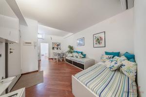 a bedroom with a bed and a living room at SeaSoul - Mare 100m - 6 Guests - Centro Storico in Albissola Marina