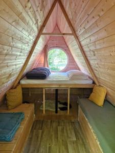 a small room with two beds in a tent at Camping De Thoissey *** in Thoissey