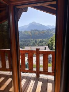 a view from a screened in porch with a view of the mountains at Chalet Mary in La Côte dʼArbroz