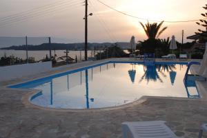 a swimming pool with a view of the water at Long View Apartments in Porto Heli