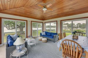 a living room with a ceiling fan and a couch at Waterfront Home with Large Yard, Dock & Bay View in Heathsville