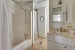 a bathroom with a tub and a sink and a shower at Waterfront Home with Large Yard, Dock & Bay View in Heathsville +31 photos