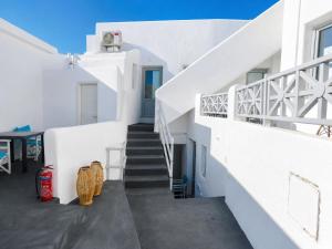 a staircase leading up to a white house at Fira Centrum White in Fira