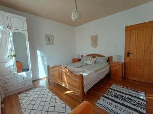 a bedroom with a bed and a dresser and a door at къща Утринна Роса in Blŭskovtsi