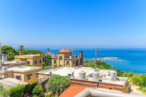 Blick auf eine Stadt mit dem Meer im Hintergrund in der Unterkunft Papiro Apart Hotel in Byblos