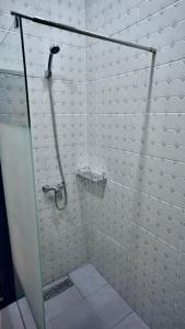 a shower with a glass door in a bathroom at Marhaba Hotel Casbah in Kasbah