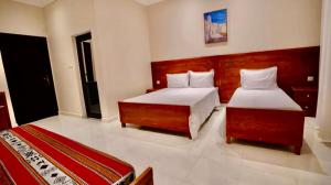 a hotel room with two beds and two beds sidx sidx sidx at Marhaba Hotel Casbah in Kasbah