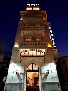 a tall building with a lit up tower at night at Marhaba Hotel Casbah in Kasbah