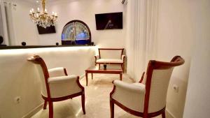 a living room with two chairs and a chandelier at Marhaba Hotel Casbah in Kasbah +13 photos