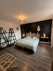 a bedroom with a bed and a wooden floor at Domaine de Camentroun in Pomarez