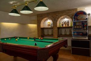 a room with a pool table and a refrigerator at Chillinn La Maison Cottage Eger in Eger