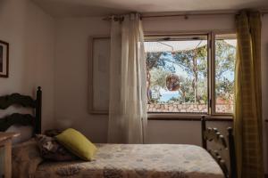 a bedroom with a bed and a window at Casa Bianca Rais Gerbi in Finale