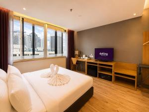 a hotel room with a bed and a flat screen tv at deKing Hotel Twin Towers by DK Hospitality in Kuala Lumpur +42 photos