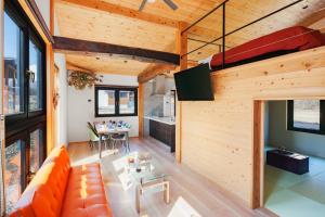 an open living room with a couch and a table at New Field Chalet 白馬 in Hakuba