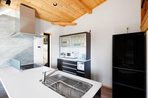a kitchen with a sink and a counter at New Field Chalet 白馬 in Hakuba