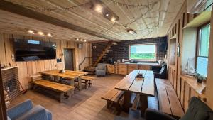 a large room with wooden tables and benches at Möllatsi Saunamaja in Möllatsi