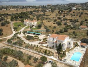 an aerial view of a villa with a swimming pool at Long View Apartments in Porto Heli