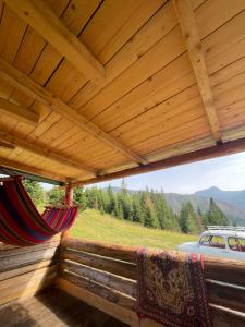 a porch with a hammock and a view of a mountain at Ivovik in Rožaje