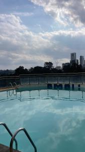 a large swimming pool with blue water on a building at Pendo suite in Nairobi