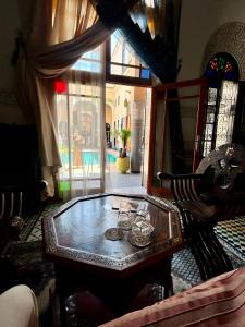 a living room with a table in a room at Riad Fes Baraka Piscine & SPA in Fez