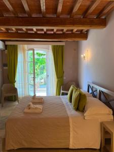 a bedroom with a large bed with green curtains at Relais dei Molini - Villa dei Molini in Castagneto Carducci +159 photos