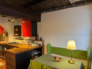 a kitchen with a table with a lamp on it at Il Rifugio - Cottage With Pool in Toano