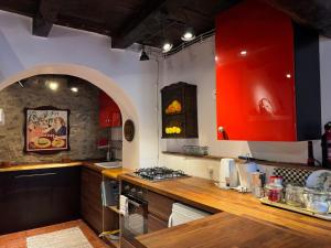 a kitchen with red cabinets and a counter top at Il Rifugio - Cottage With Pool in Toano