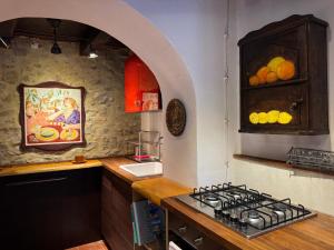 a kitchen with a stove and a counter top at Il Rifugio - Cottage With Pool in Toano