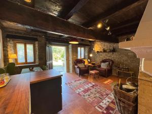 a large living room with a table and chairs at Il Rifugio - Cottage With Pool in Toano