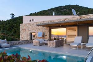 a villa with a swimming pool and a house at Atrium Villas in Kechria